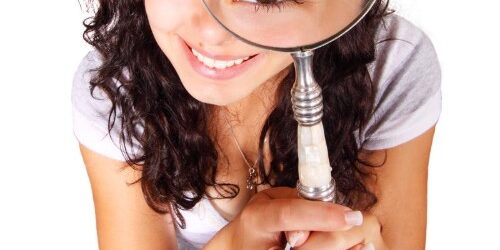 Woman with a magnifying glass looking for a job