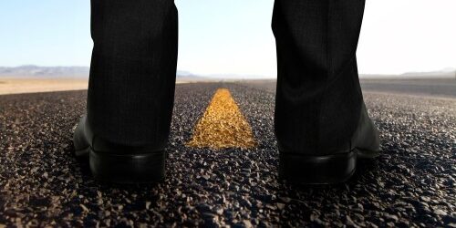 Man standing on the road thinking about a career change