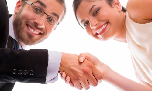 HappyHiring Happy people shaking hands after interviewing for a job