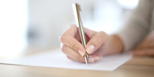 Woman writing her Career in Review