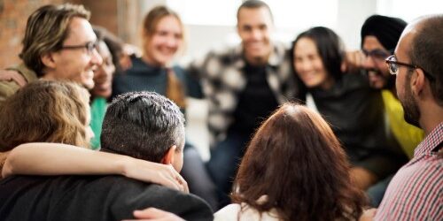 Diverse team huddled together in the workplace