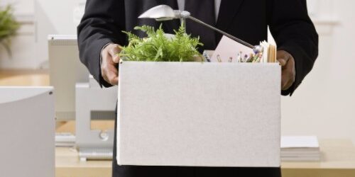 Fired Employee Leaving with Box of Personal Belongings