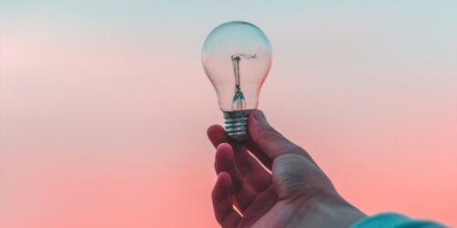 Entrepreneur Entrepreneur with an Idea Aolding a Light Bulb