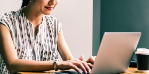 UpdatingResume Woman sitting at a computer updating her resume for a career change