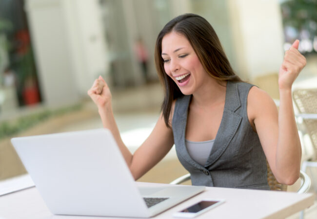 Business woman celebrating her online success